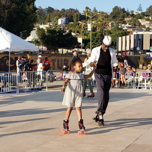 Man and Girl Roller Skating - Black Cultural Zone