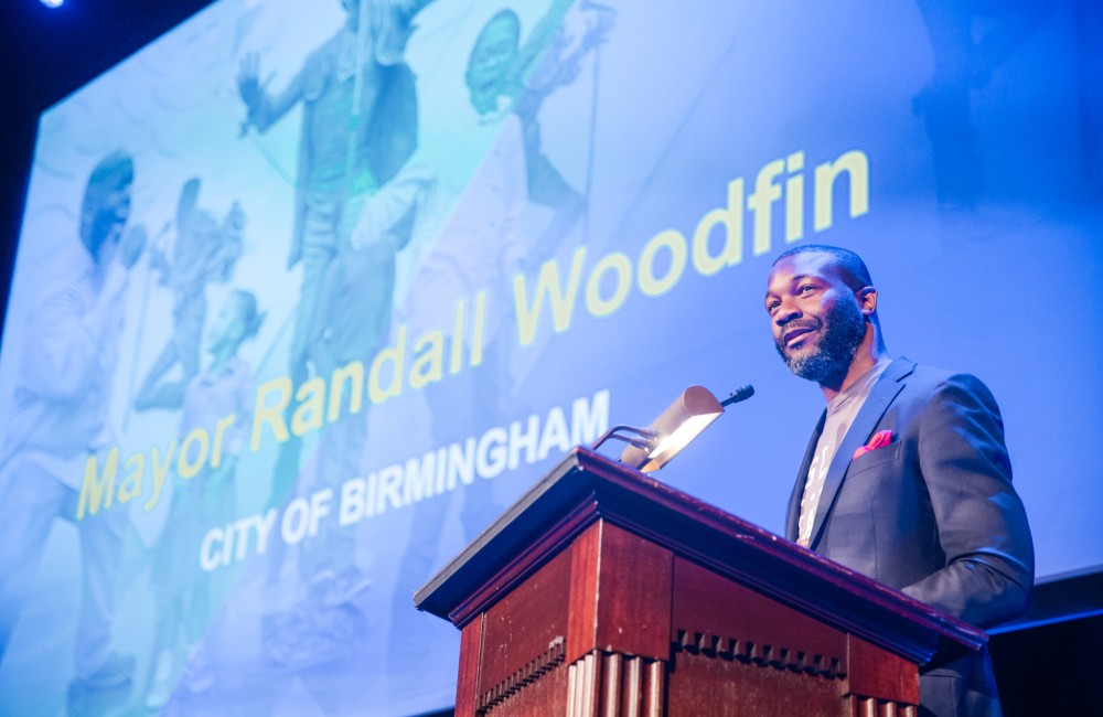 A man speaks from behind a podium.