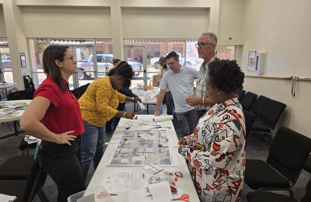 People gathered around a table looking at city plans