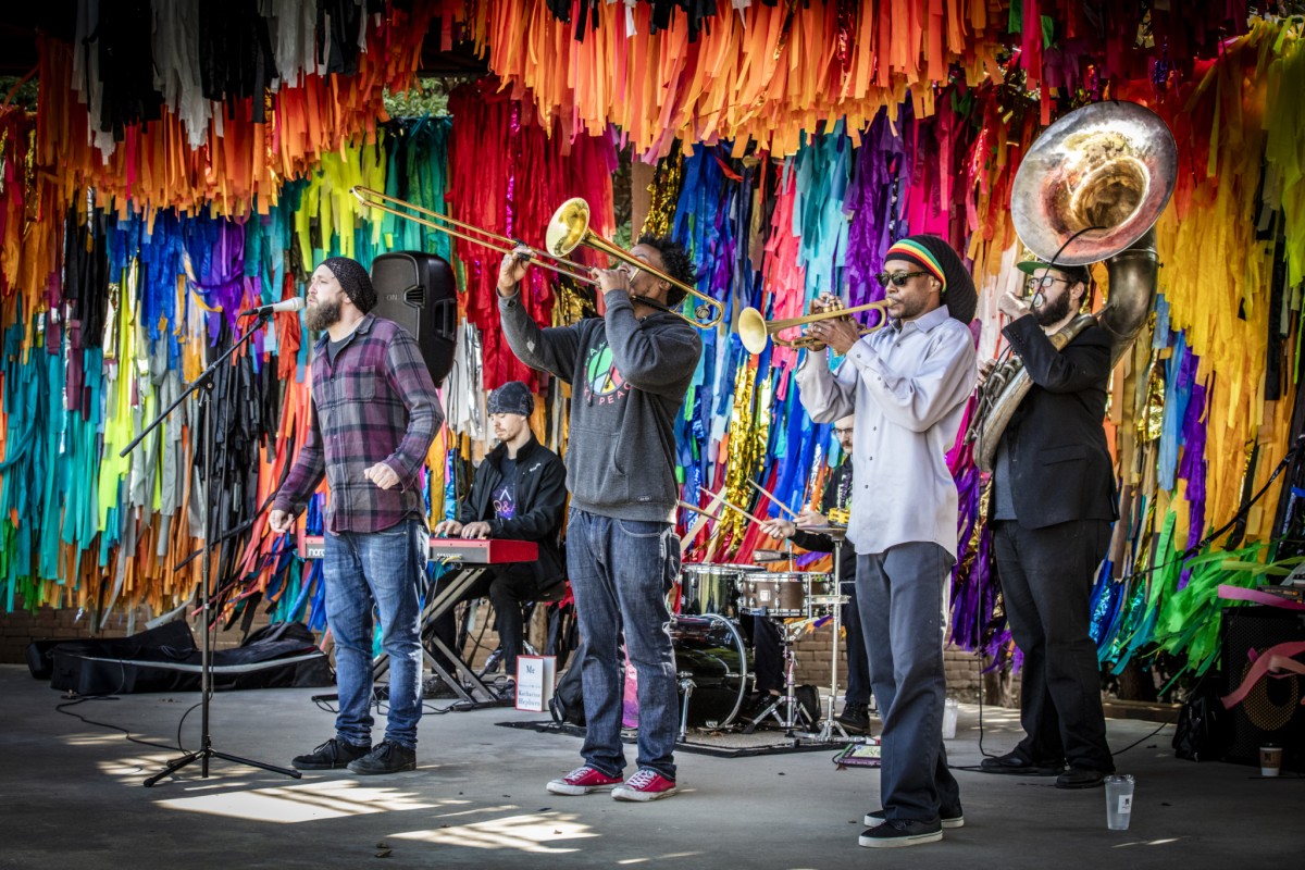 Six musicians perform on a stage.