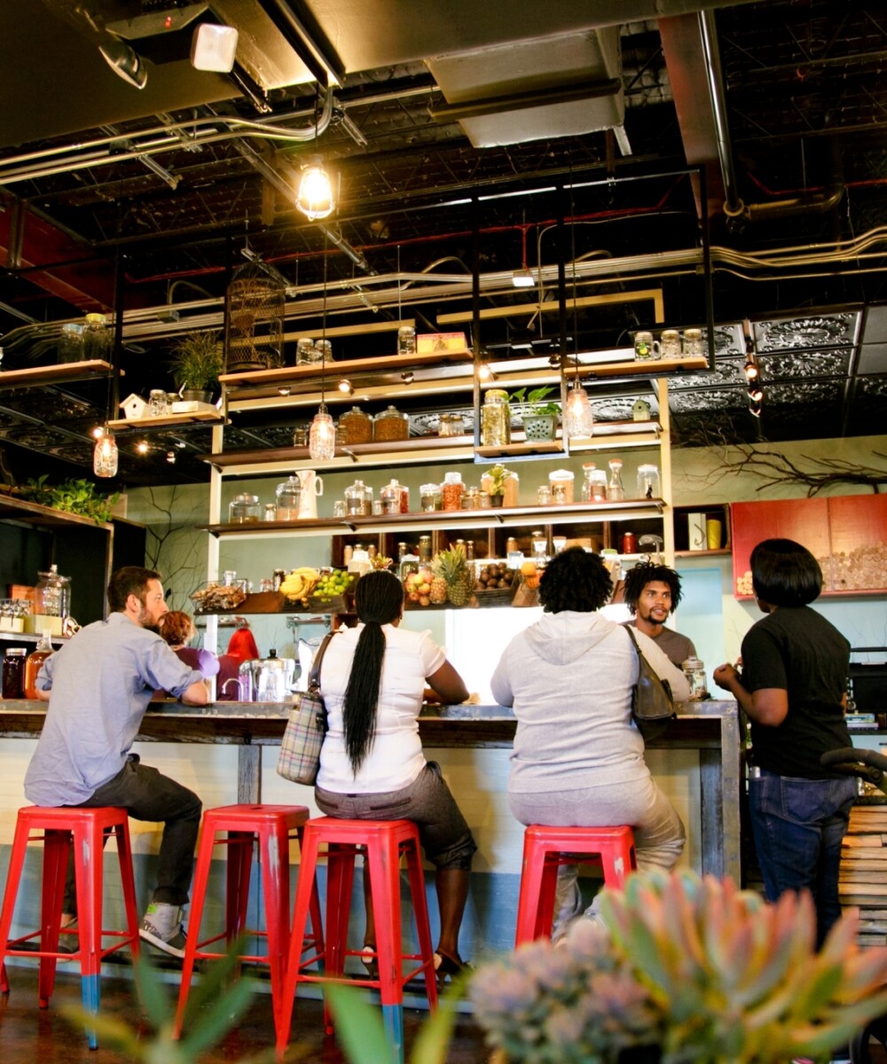 People sitting at a bar in a small restaurant