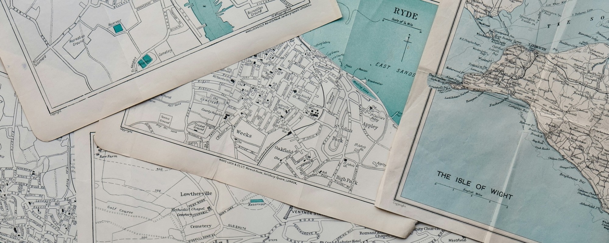 A bunch of maps laid out on a table