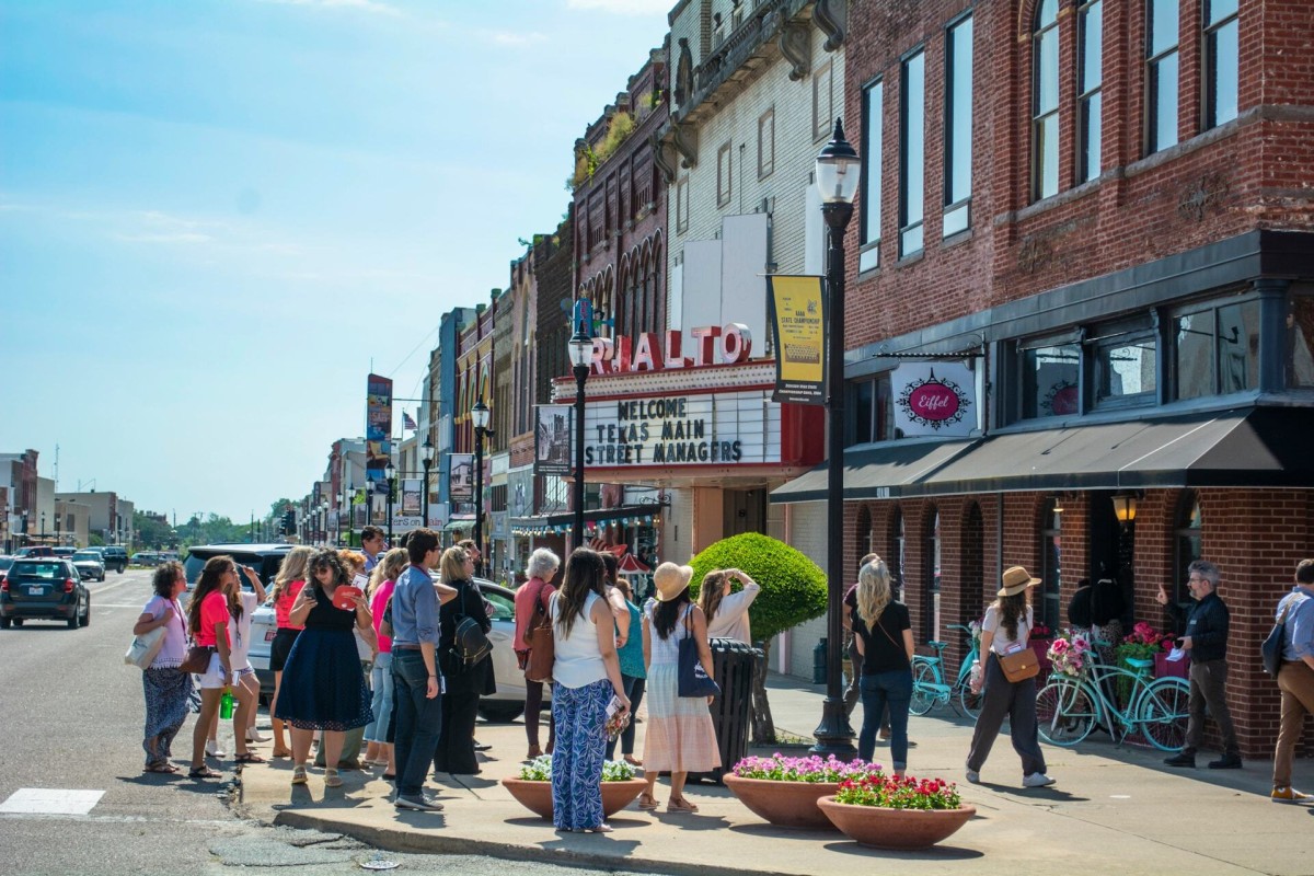 Large tour being led through Downtown Denison Main Street