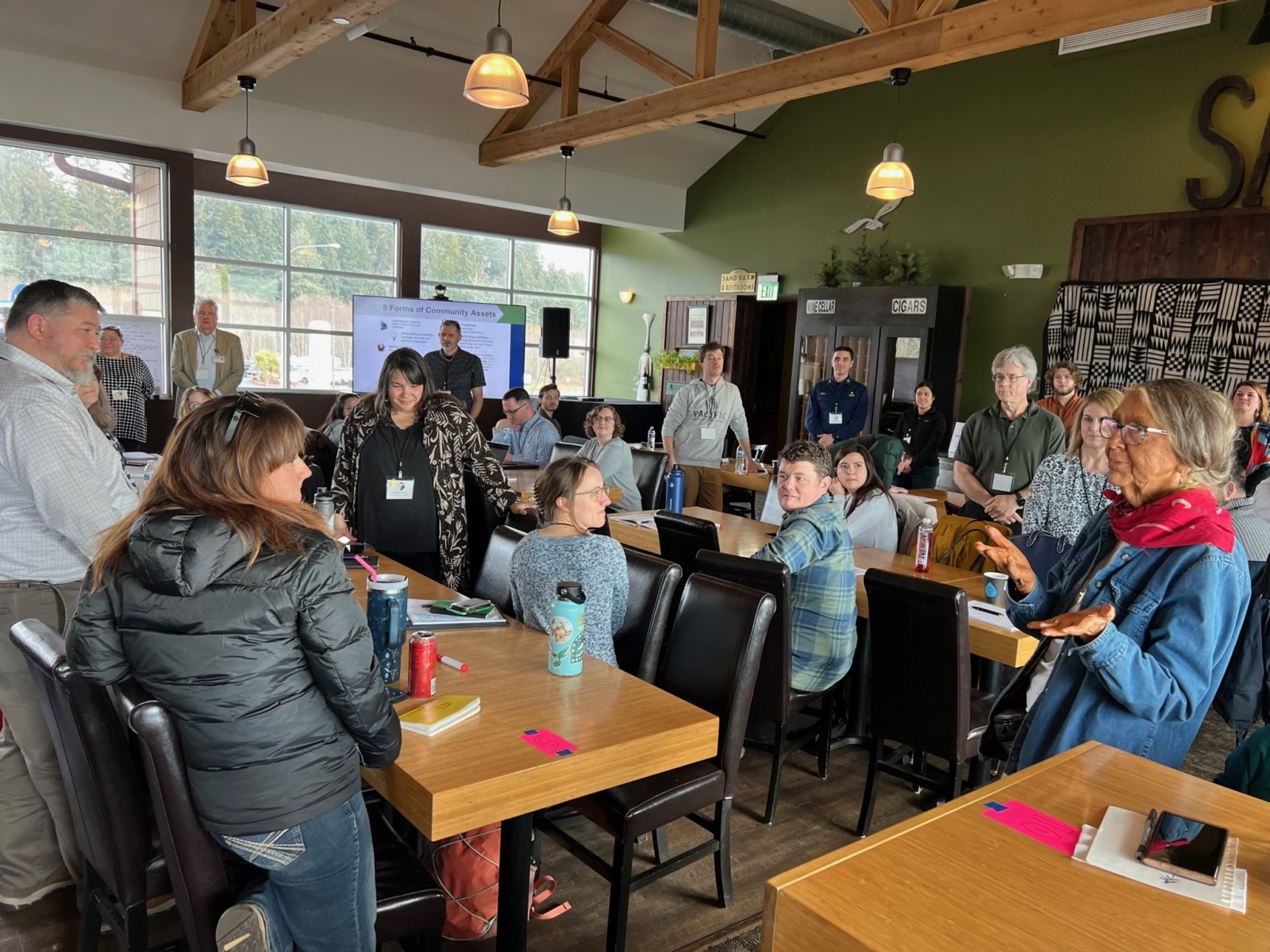 Group of people gather in conference room
