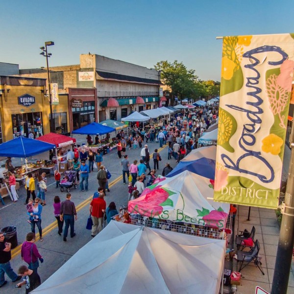 Aerial view of busy downtown street with pedestrians and vendors.