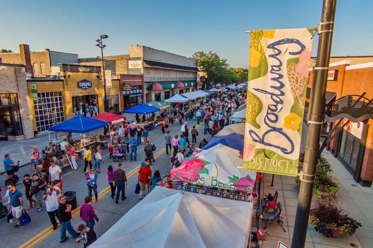 Aerial view of busy downtown street with pedestrians and vendors.