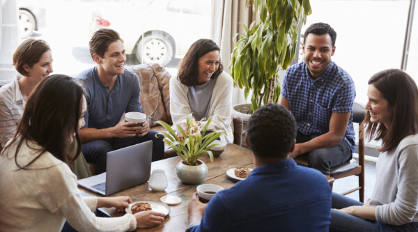 Group of young adults having a meeting at a coffee shop.