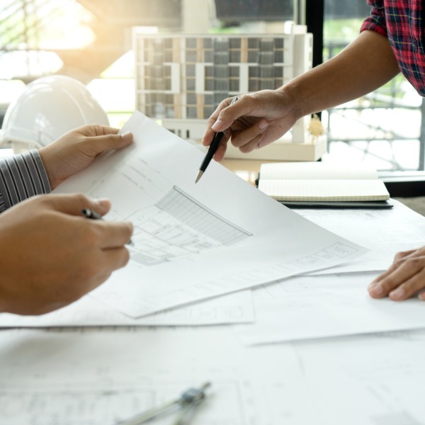 Two people look at architectural drawings