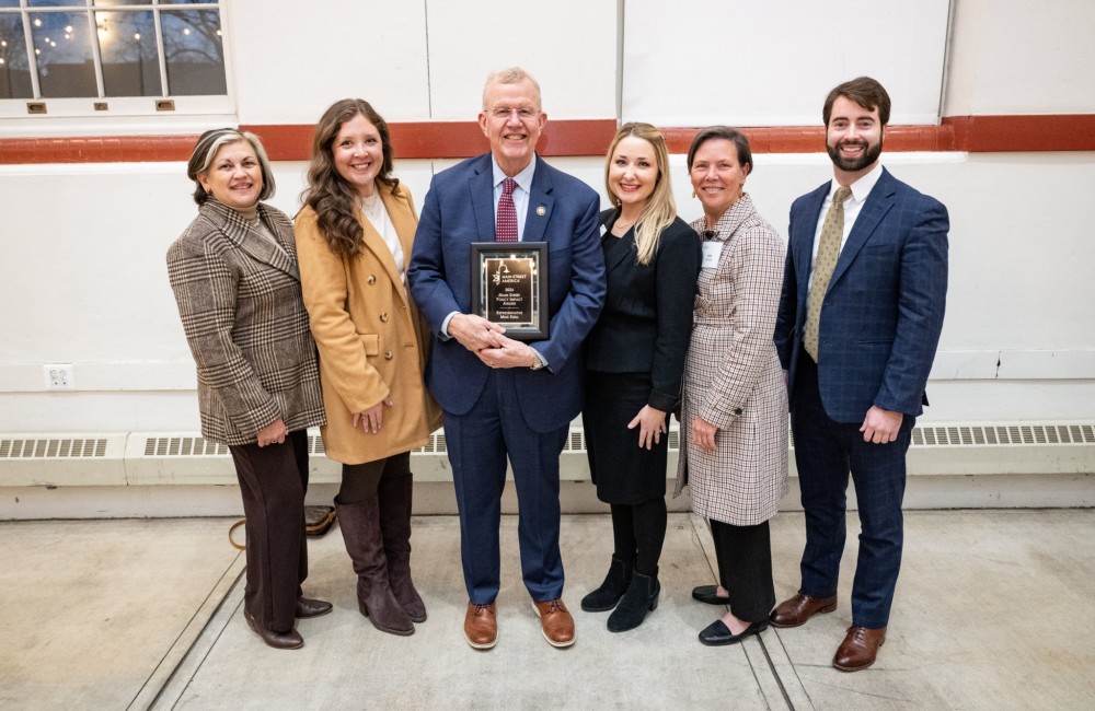 Mike Ezell poses with a group after receiving his award