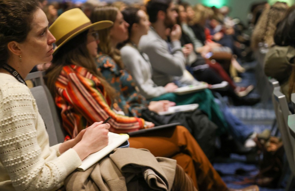 People seated and listening intently.
