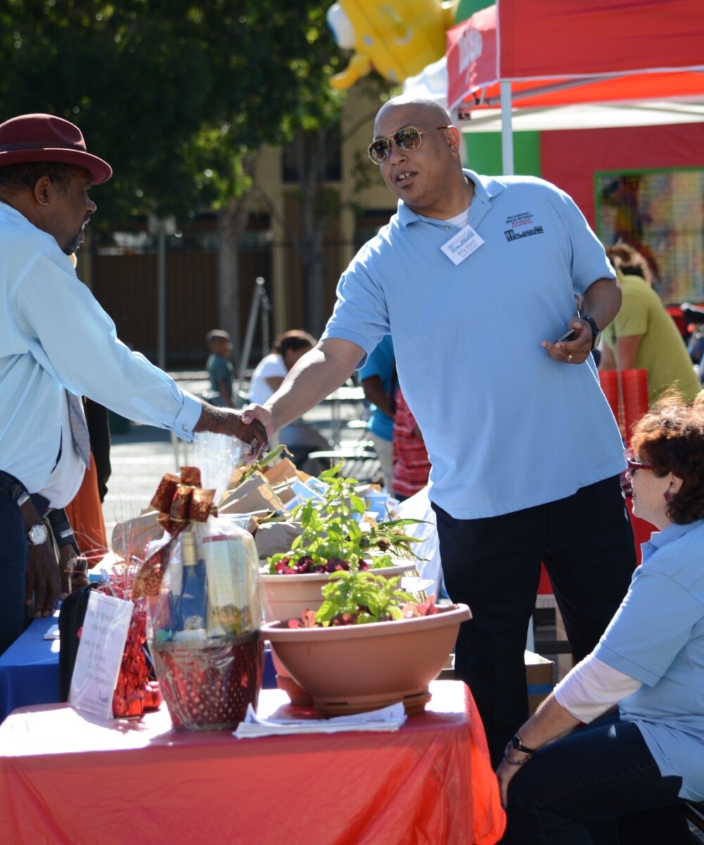 Men shaking hands at a community event.