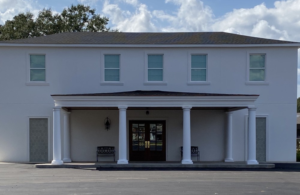 Renovated exterior of a neo-classical two-story building.