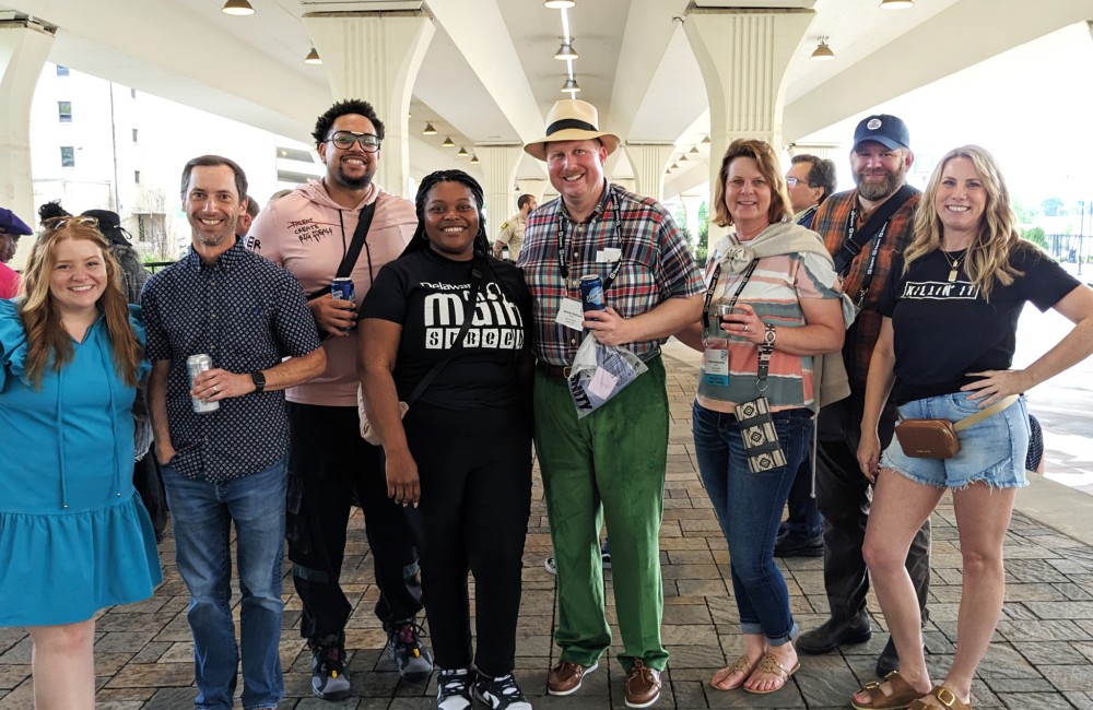 A group of people pose for a photo in a plaza.