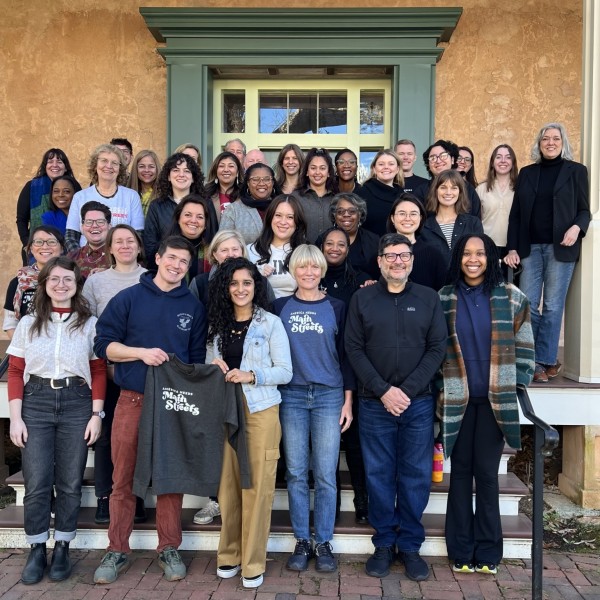 Main Street America staff members stand on stairs.