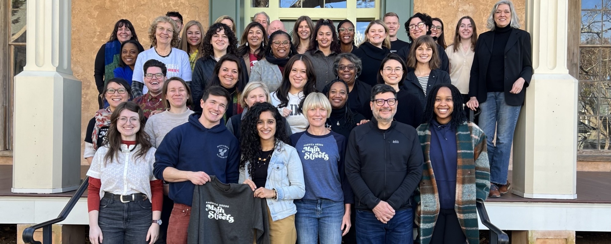 Main Street America staff members stand on stairs.