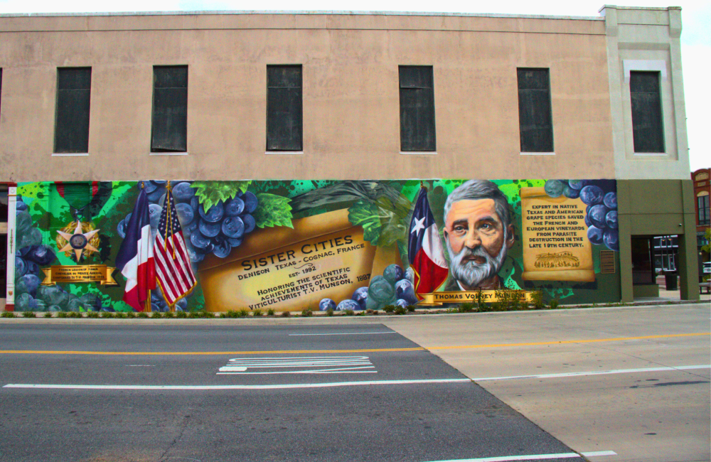 Photo of a large mural painted on the side of a storefront.