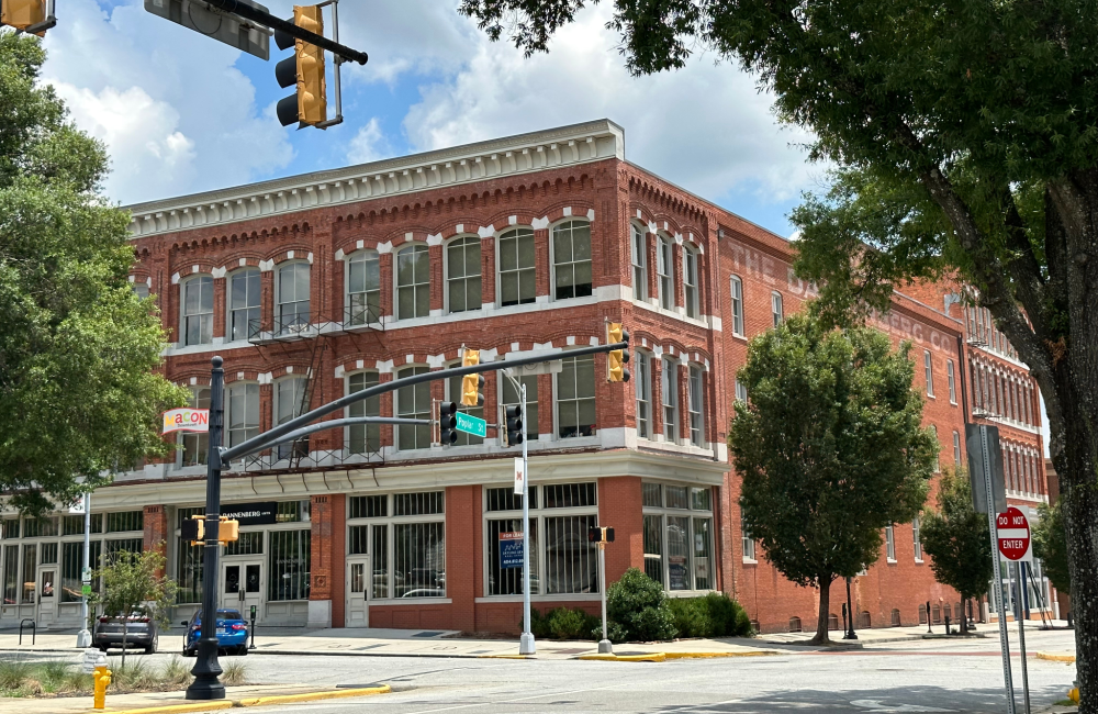 Exterior of a beautifully restored three-story historic brick building.