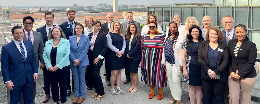 Participants at the first annual Hill Day pose in front of the Washington Memorial