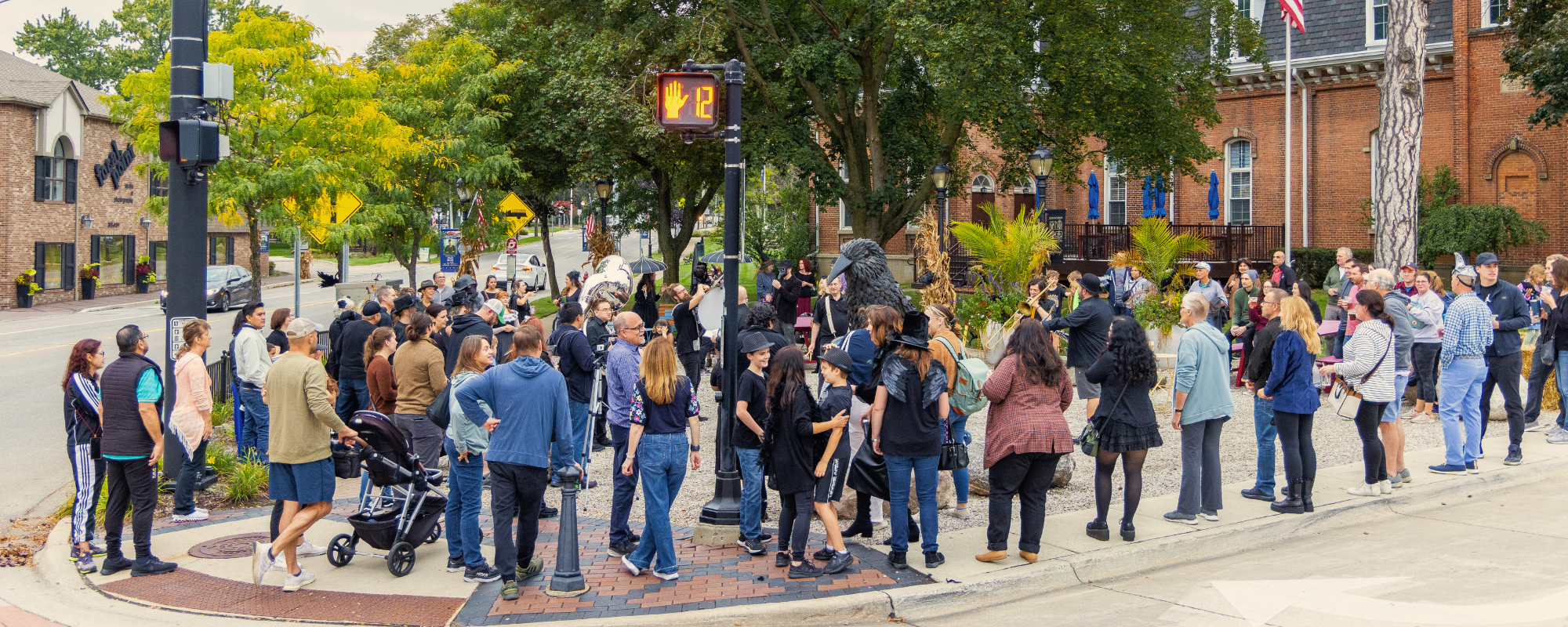 A large crowd of people standing on a street corner
